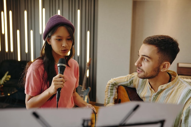 Student practicing breathing exercises in modern music training studio