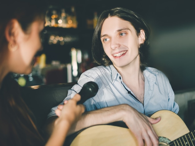 Professional vocal training instructor demonstrating singing techniques during lessons